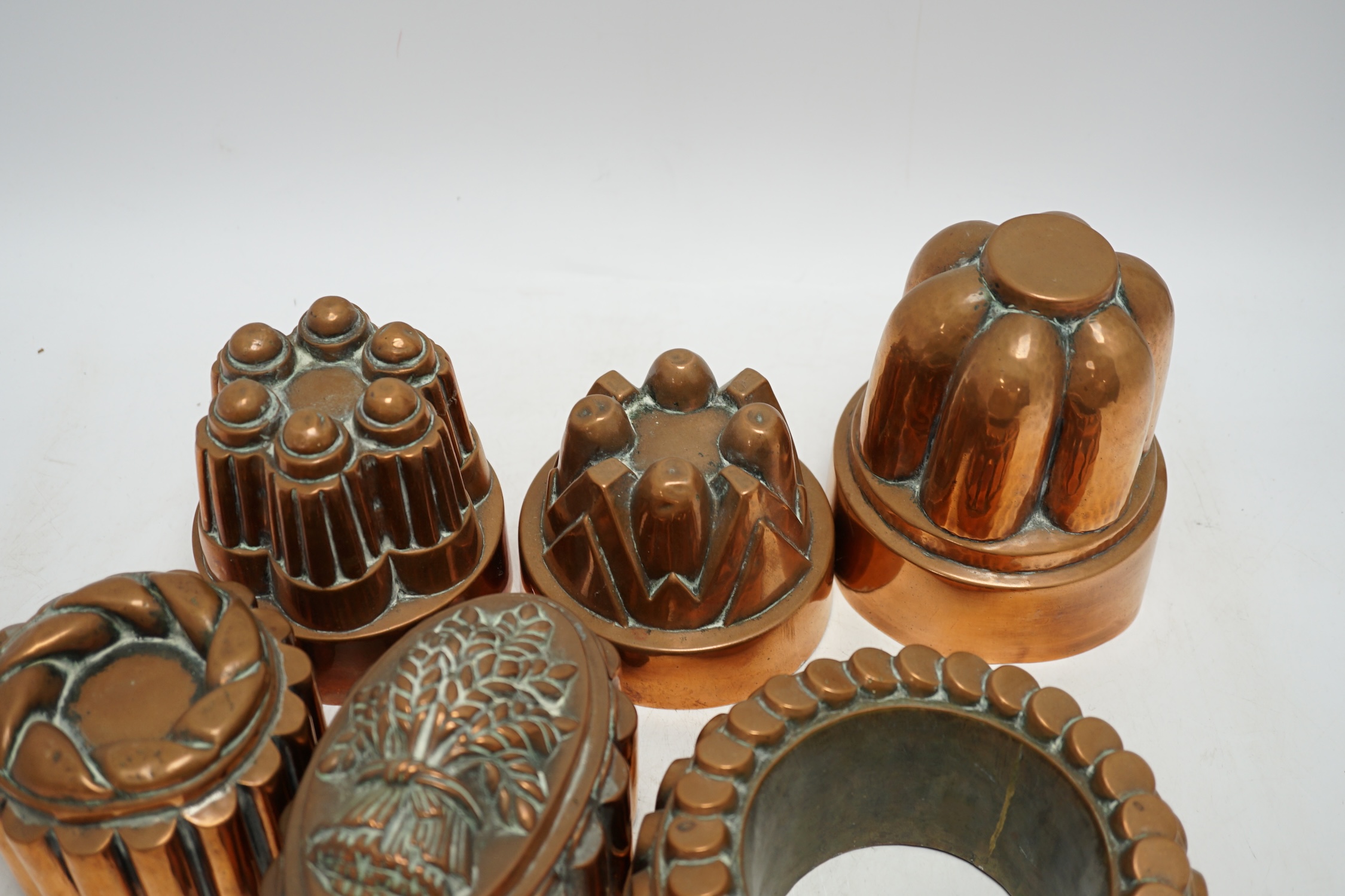 Six Victorian copper jelly moulds, tallest 14.5cm high. Condition - good